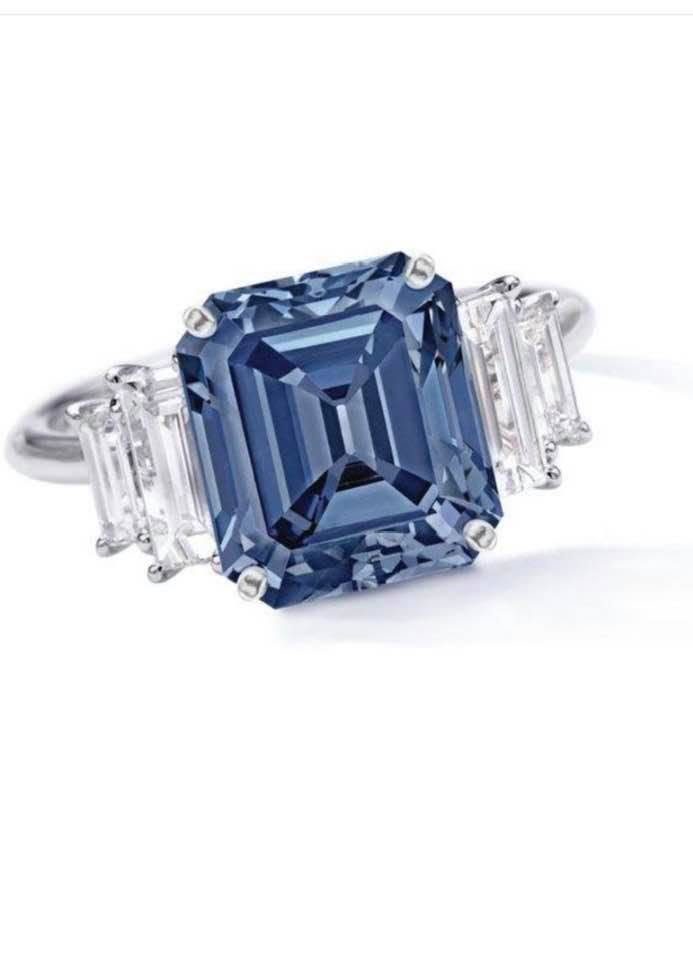 Fancy blue emerald cut flanked by matched trapezoid side stones